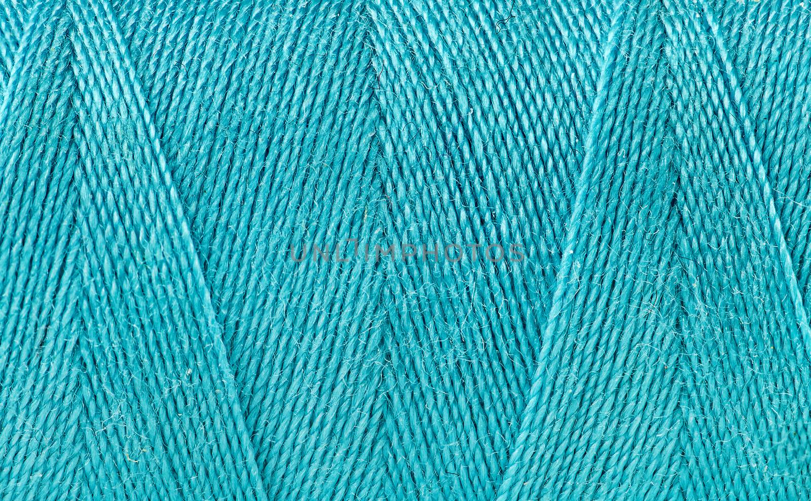 Abstract background blue thread spooled on a bobbin