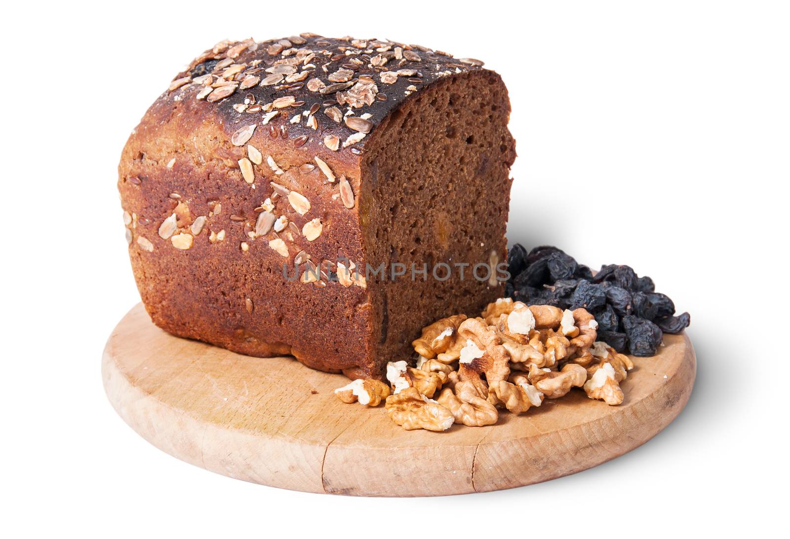 Bread with seeds on wooden board with raisins and nuts by Cipariss
