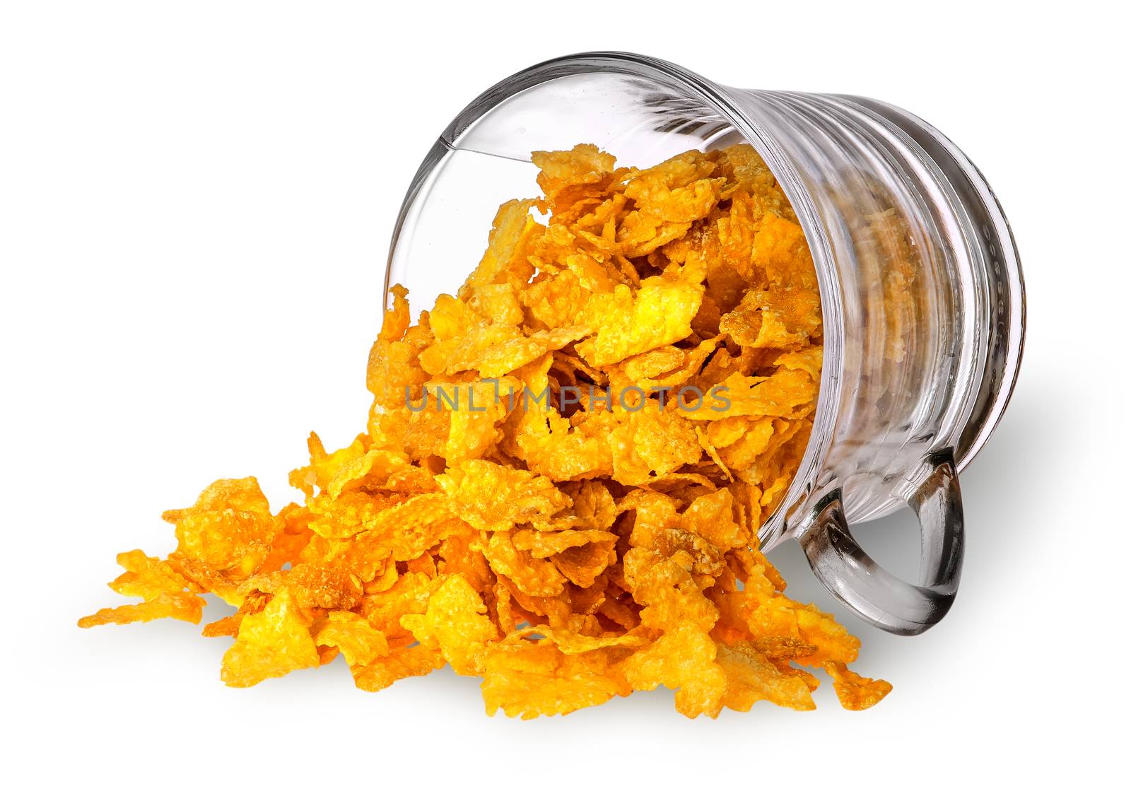 Cornflakes spill out of a glass cup isolated on white background