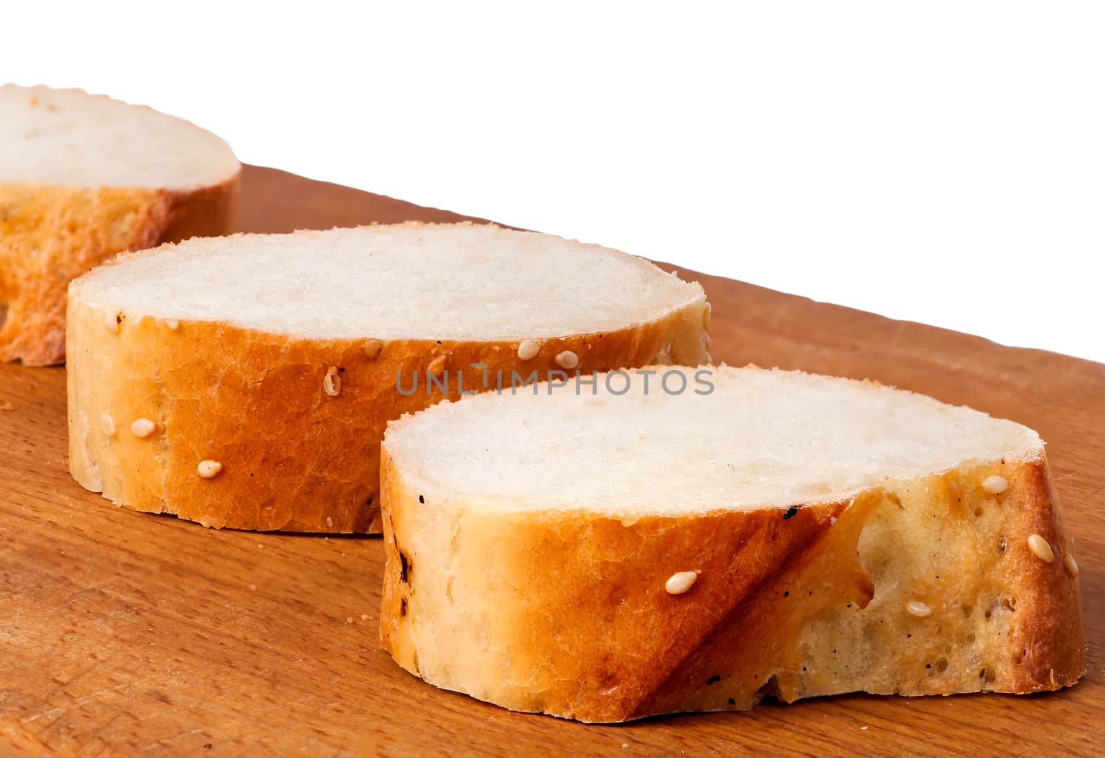 Delicious fresh bread sliced on a wooden board by Cipariss