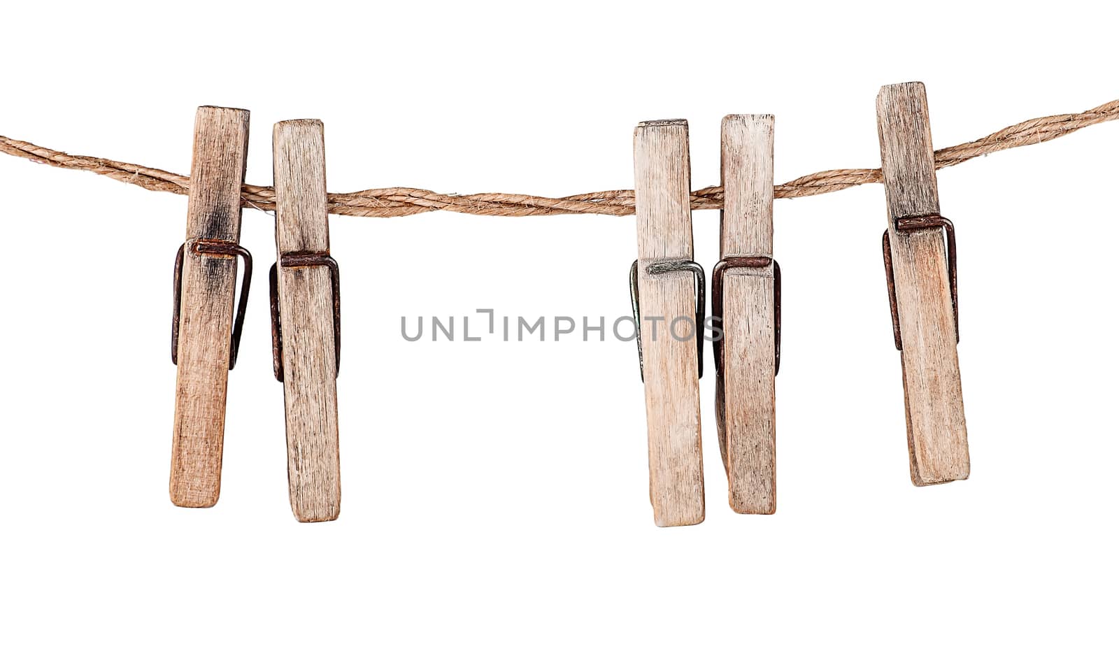 Five old clothespins on rope isolated on white background