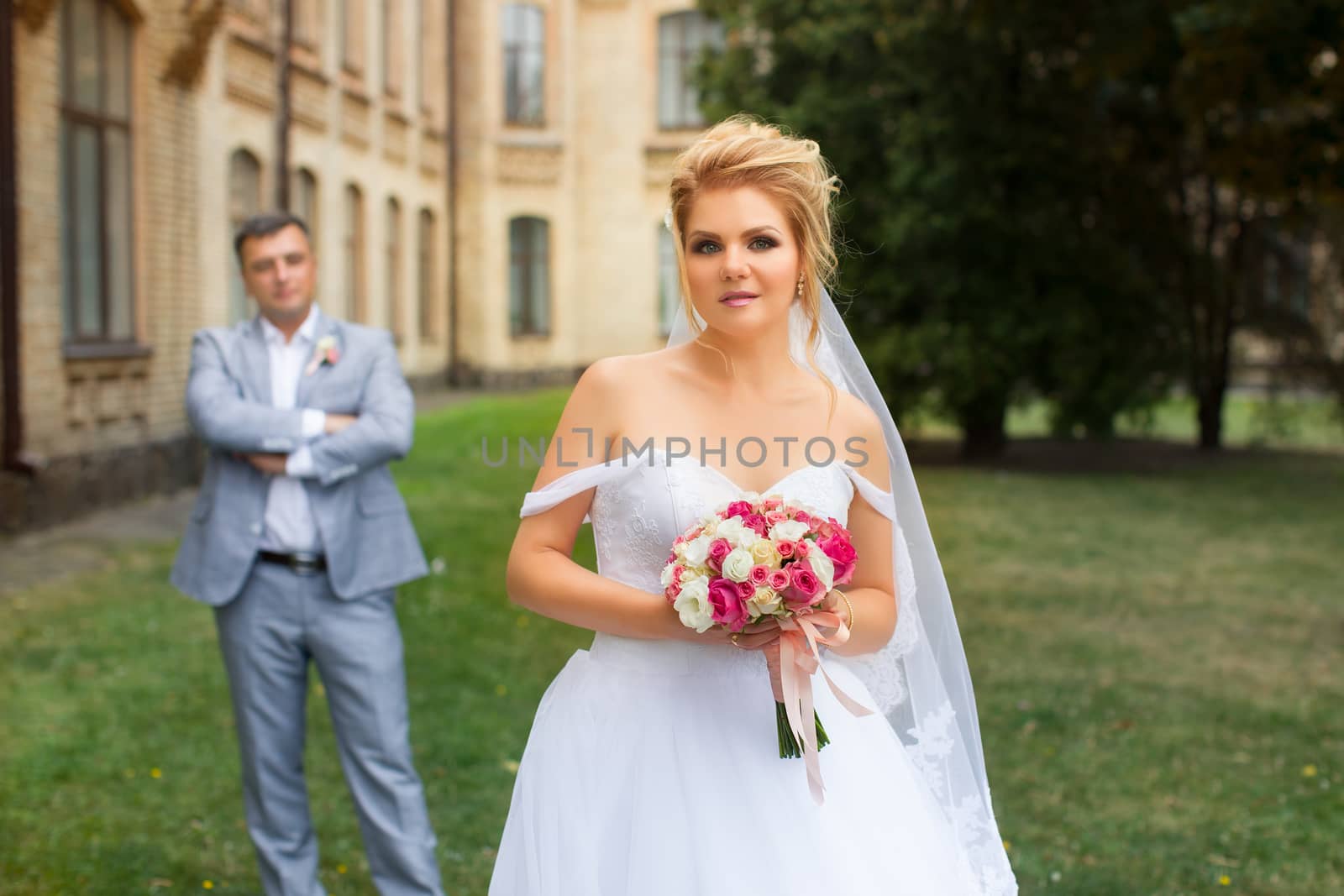 Newlyweds on a walk in the summer day wedding