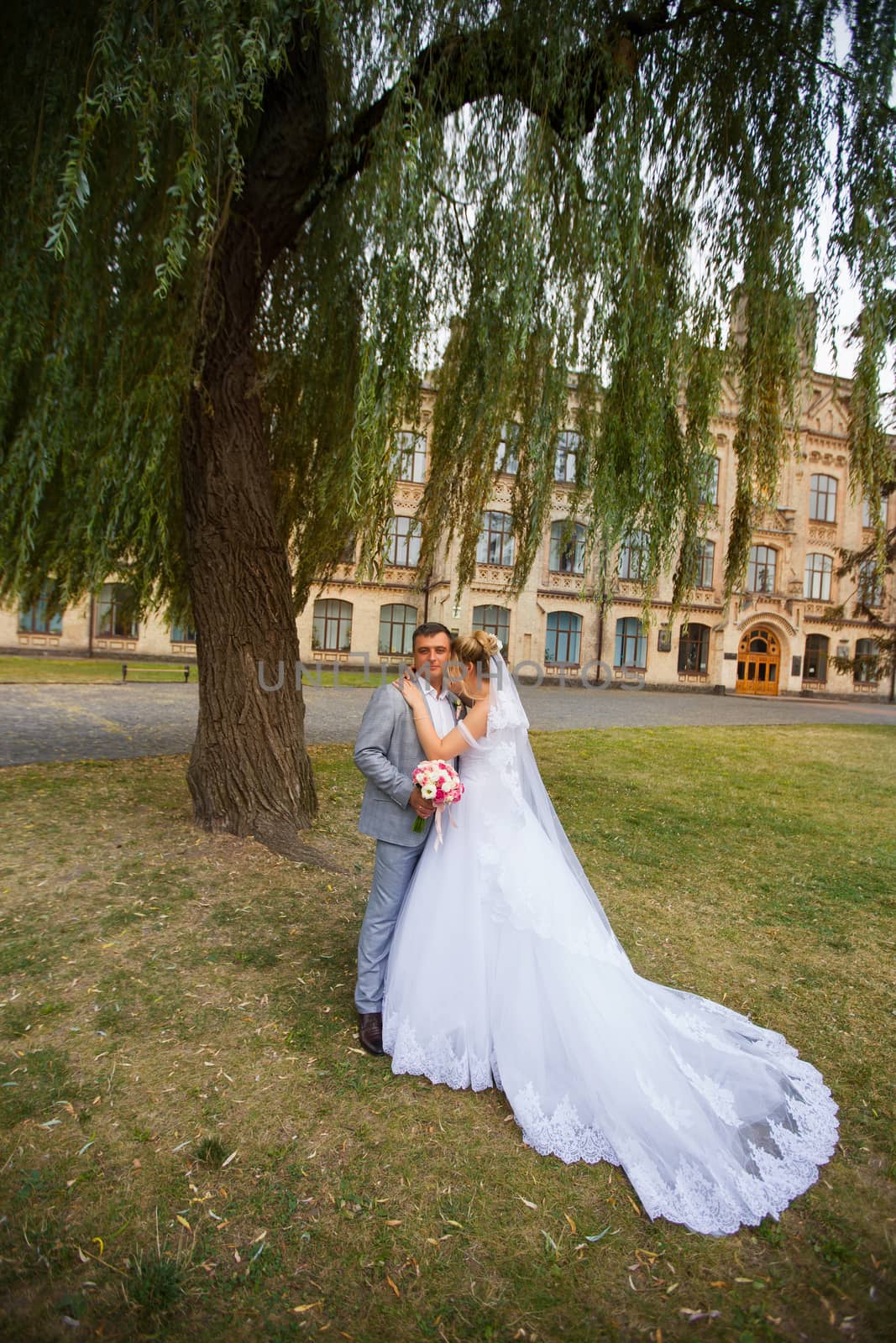 Newlyweds on a walk in the summer day wedding