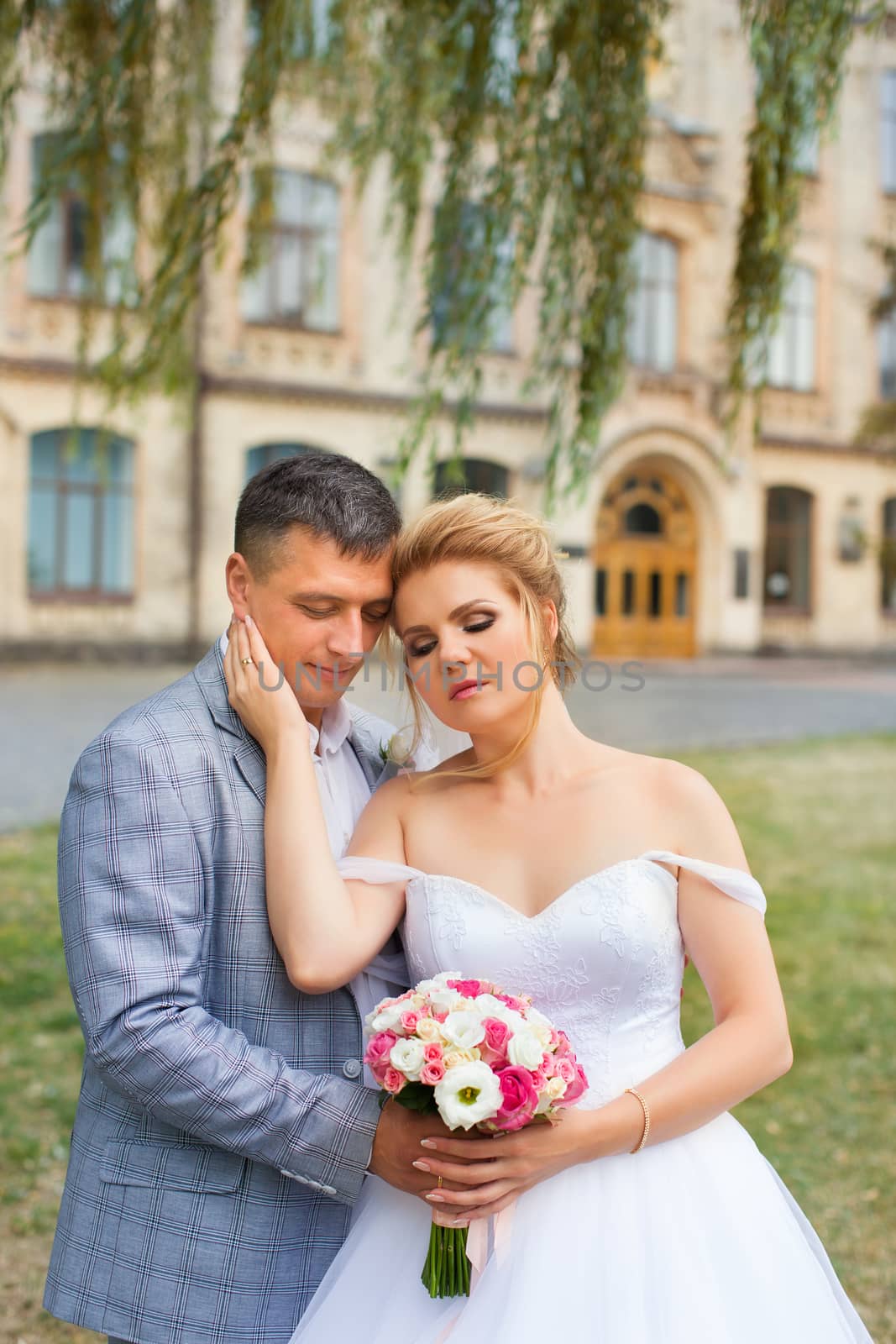 Newlyweds on a walk in the summer day wedding