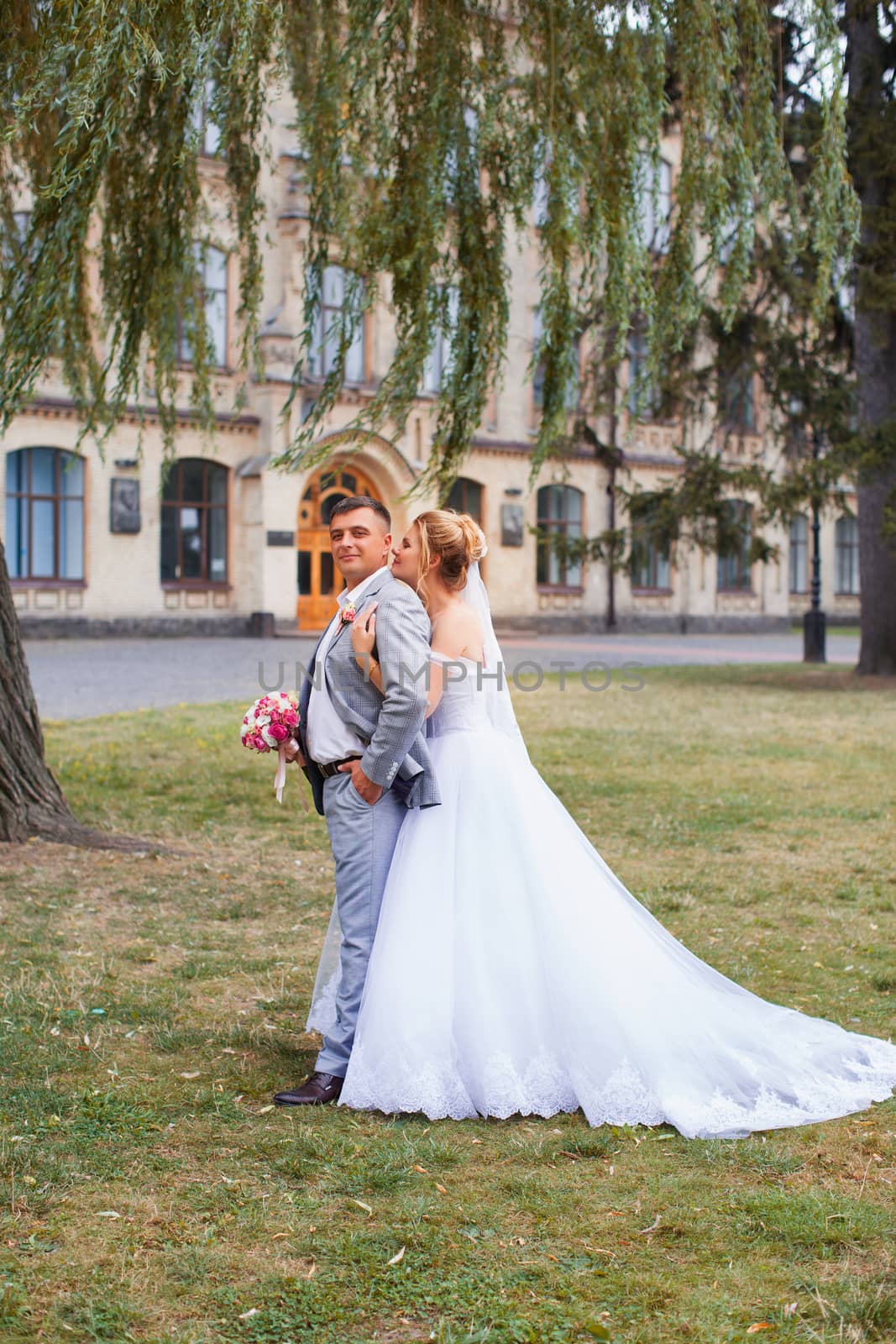 Newlyweds on a walk in the summer day wedding