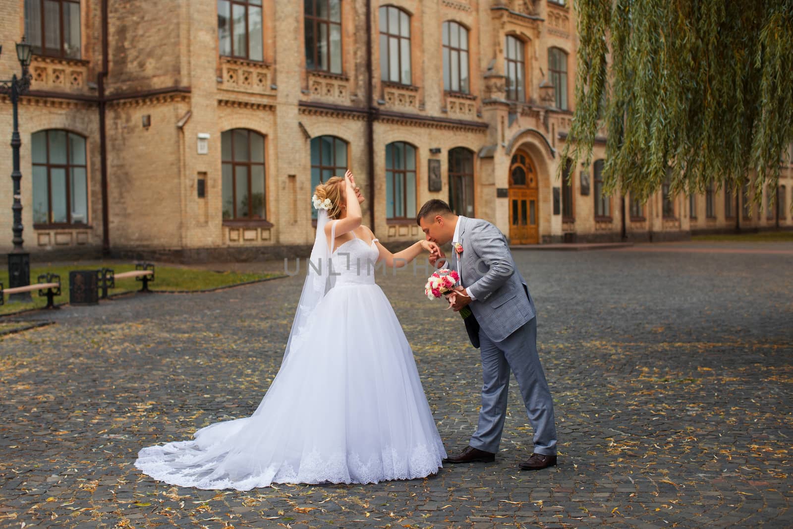 Newlyweds on a walk in the summer day wedding