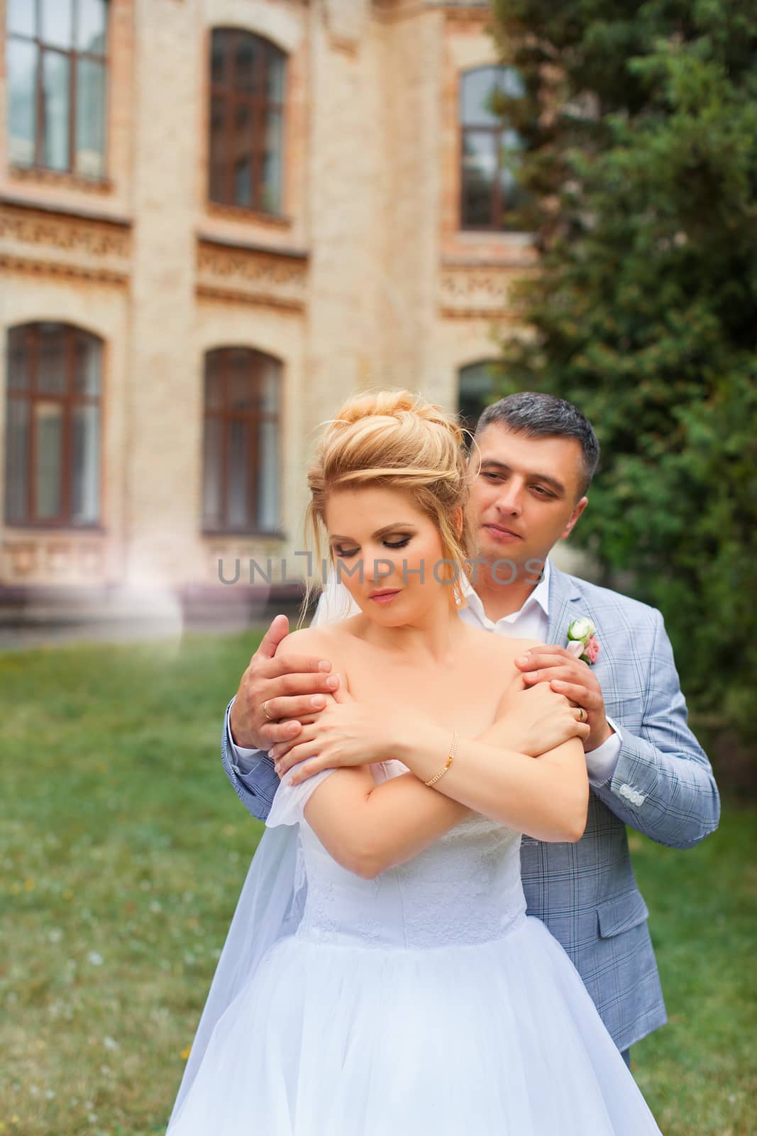 Newlyweds on a walk in the summer day wedding