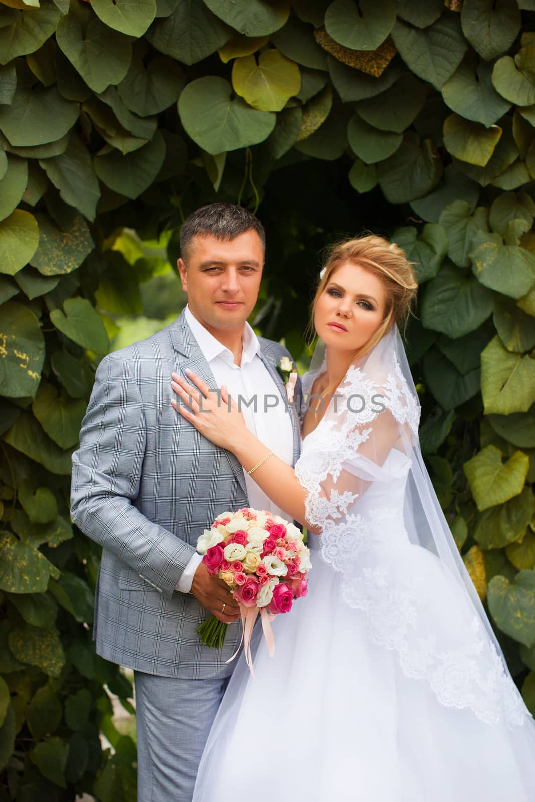 Newlyweds on a walk in the summer day wedding