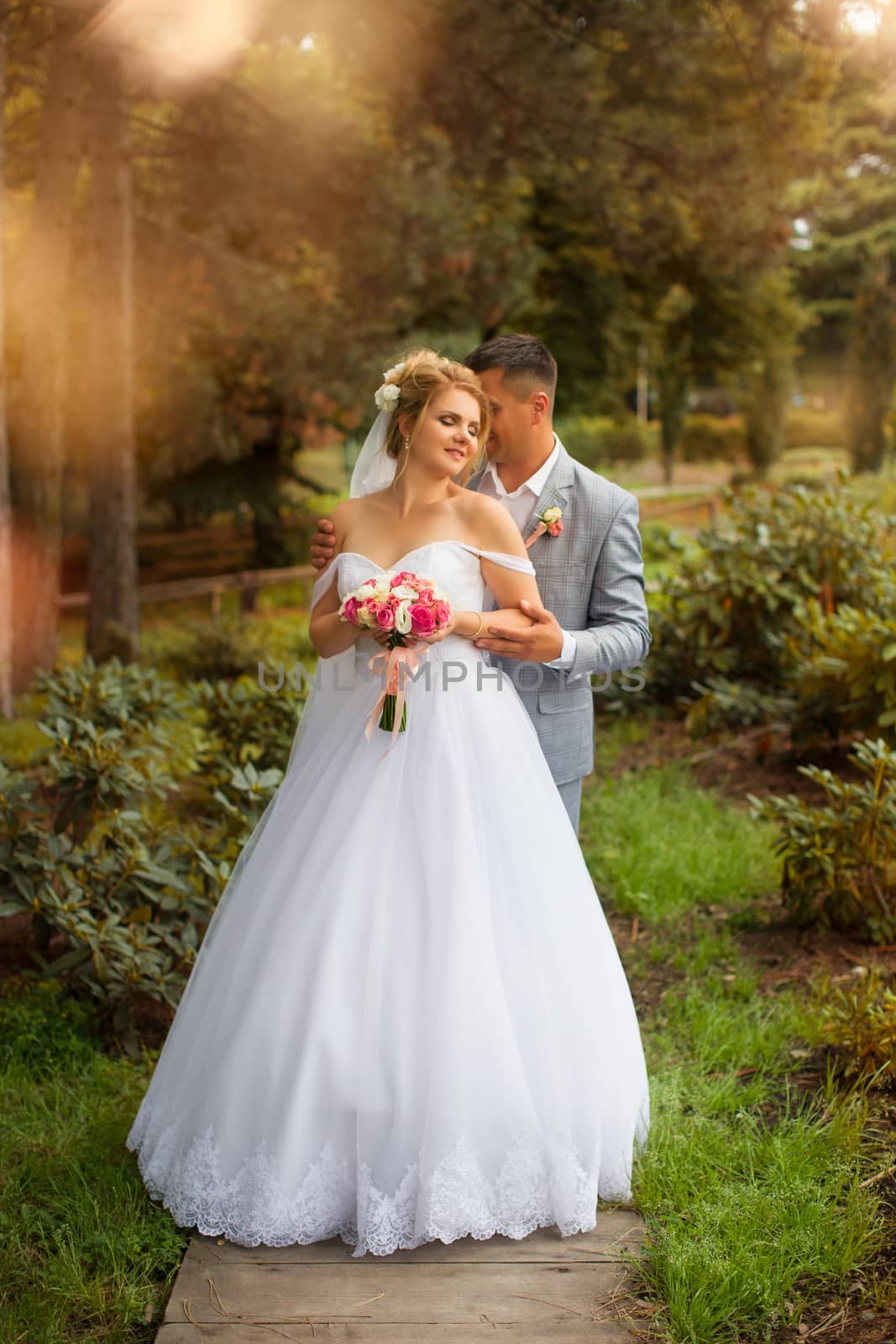 Newlyweds on a walk in the summer day wedding