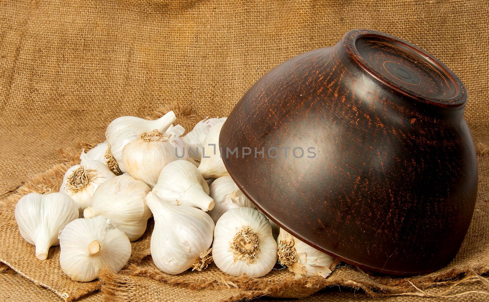 Garlic spill out of a ceramic bowl by Cipariss