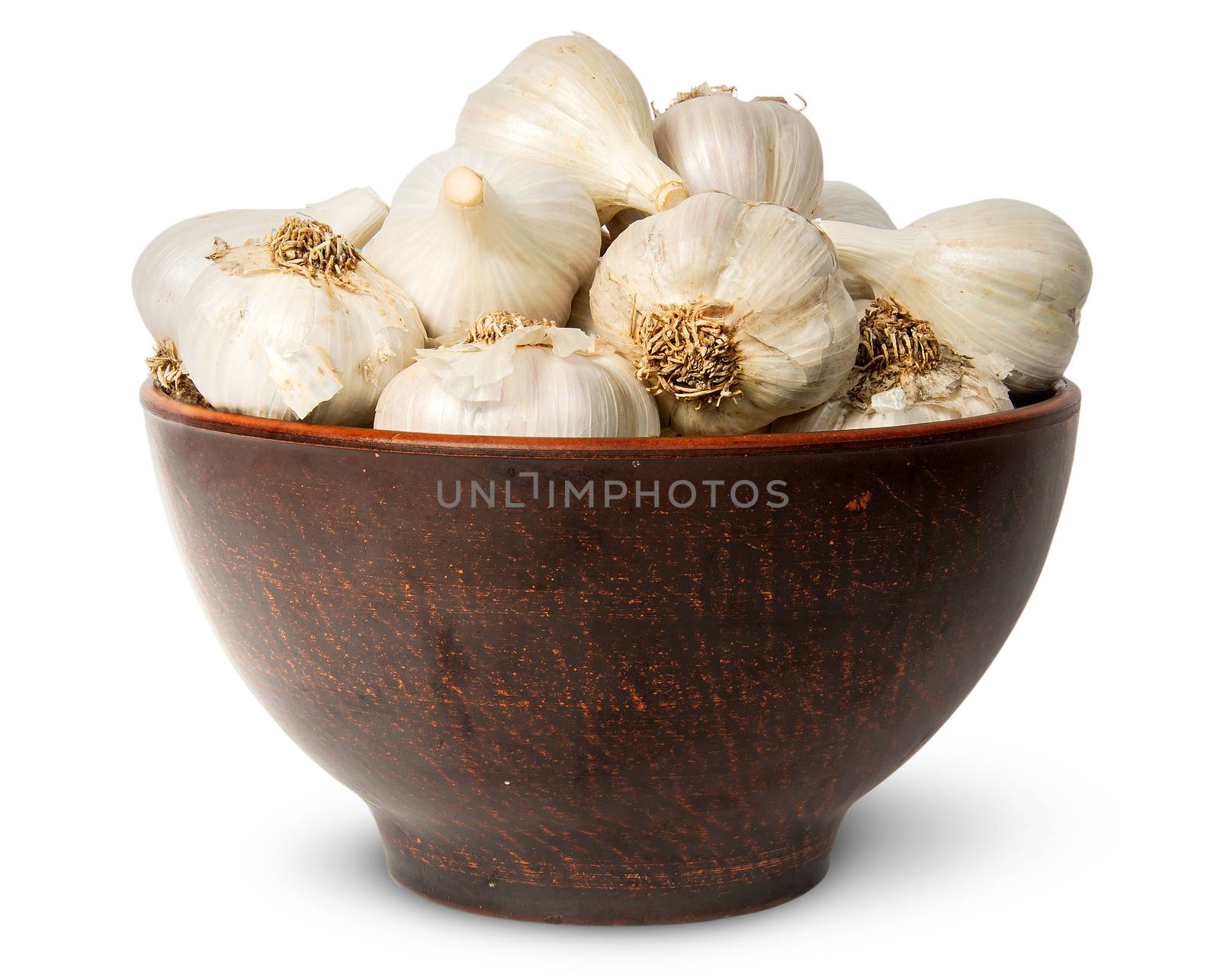 In front whole head of garlic in ceramic bowl isolated on white background