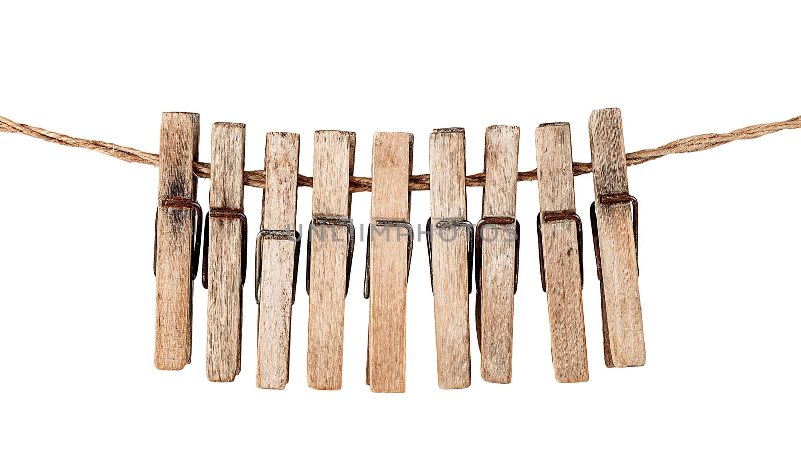Many old wooden clothespins on a rope isolated on white background