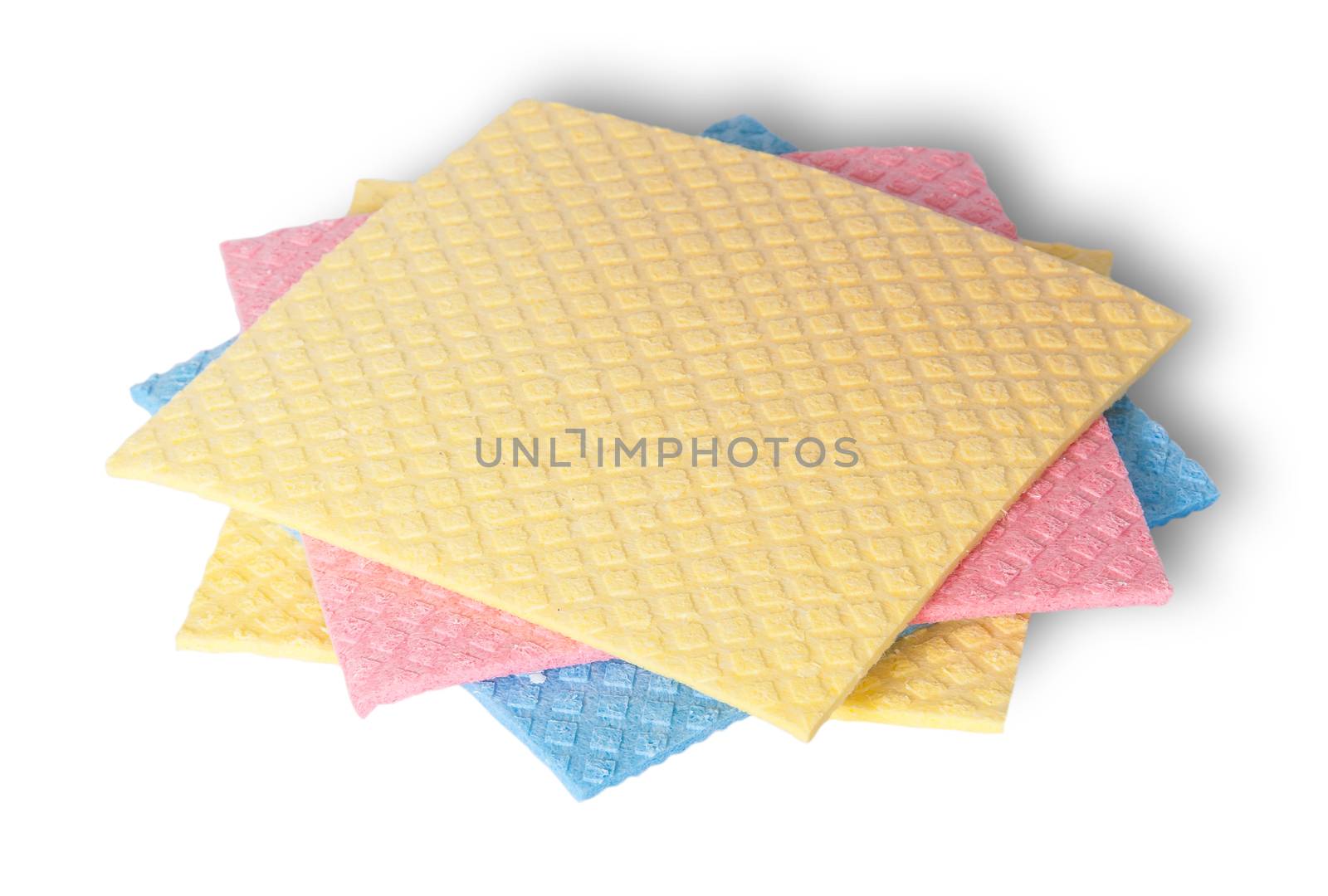 Multicolored sponges for dishwashing in a chaotic order isolated on white background
