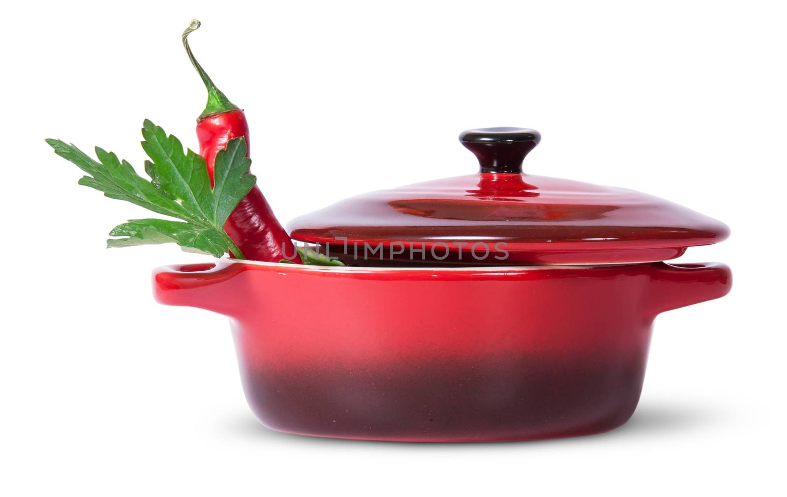 Parsley with red chili pepper in saucepan by Cipariss