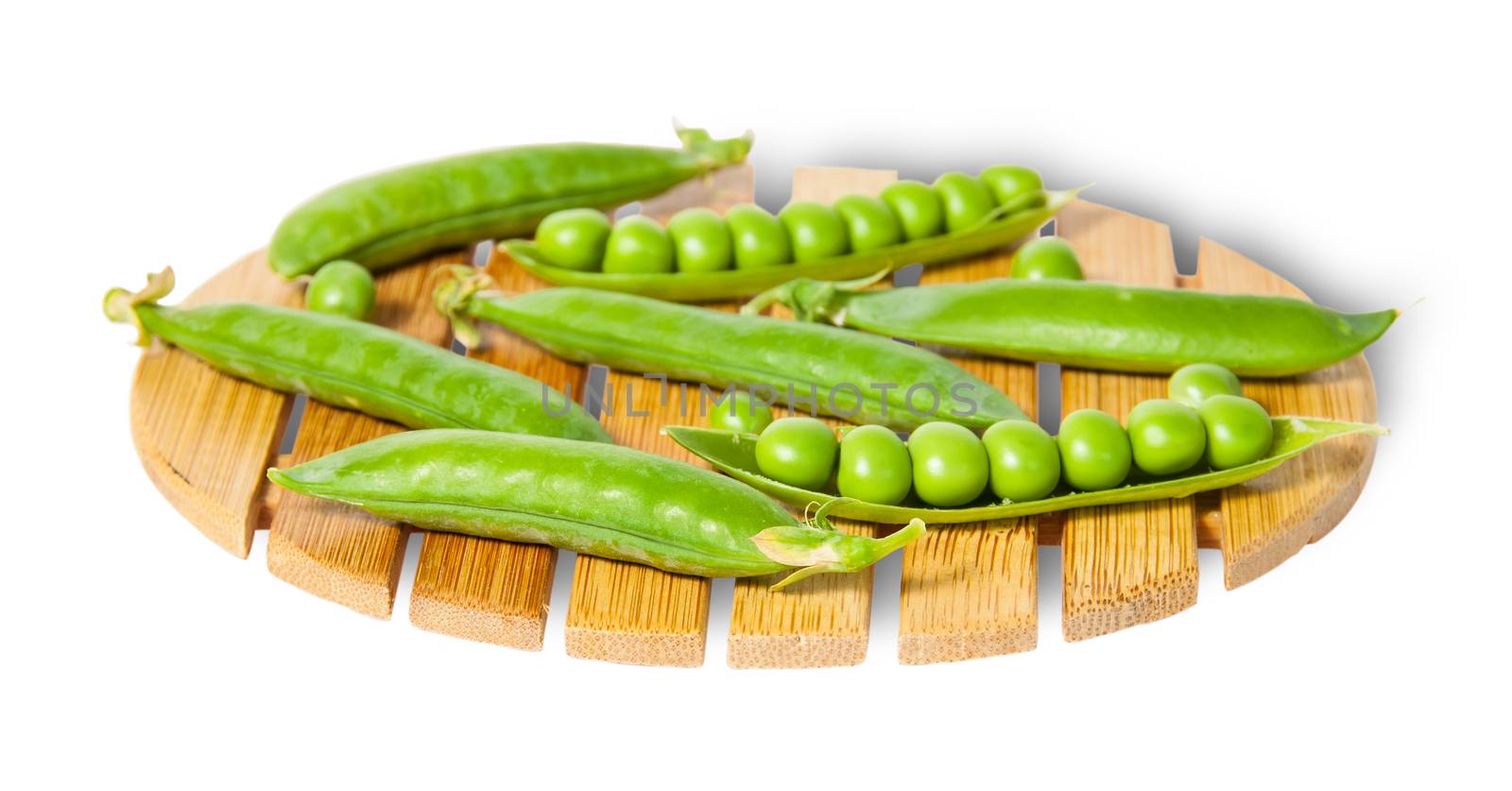 Pods of peas on bamboo small board isolated on white background