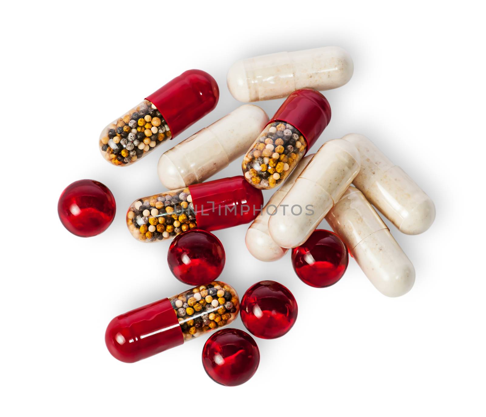 Scattered pills and capsules different color isolated on white background