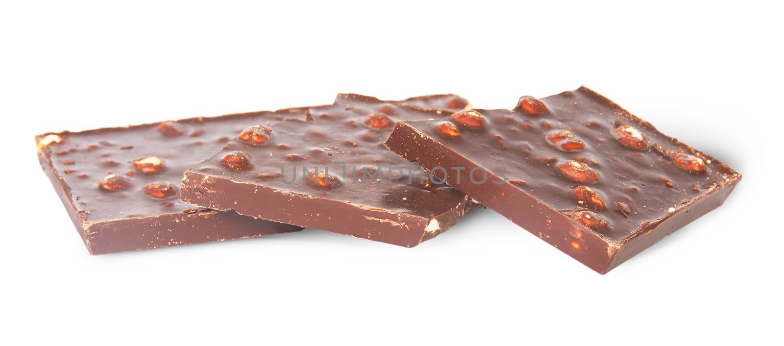 Several pieces of dark chocolate with hazelnuts isolated on white background