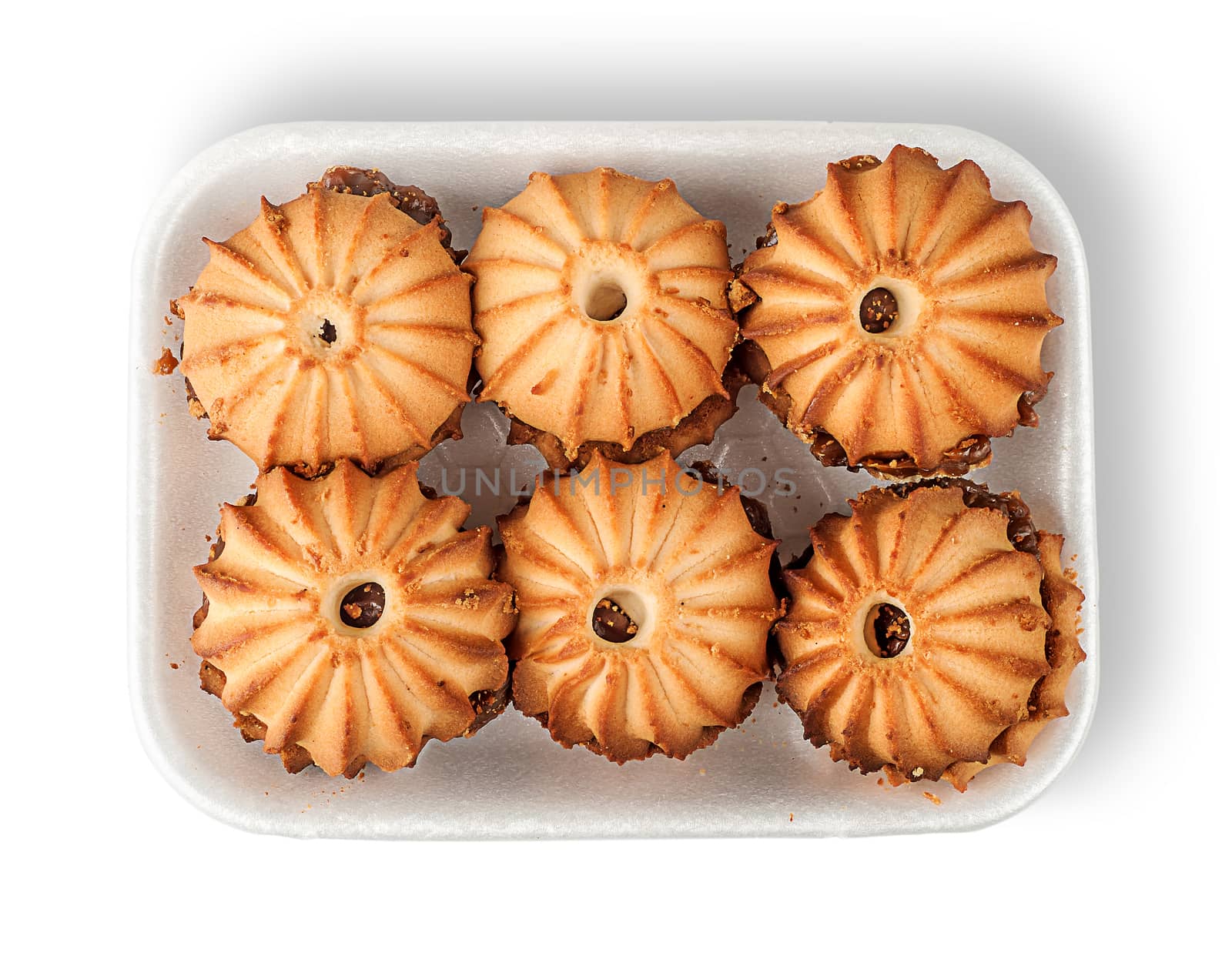 Shortbread biscuits with filling in plastic tray top view isolated on white background