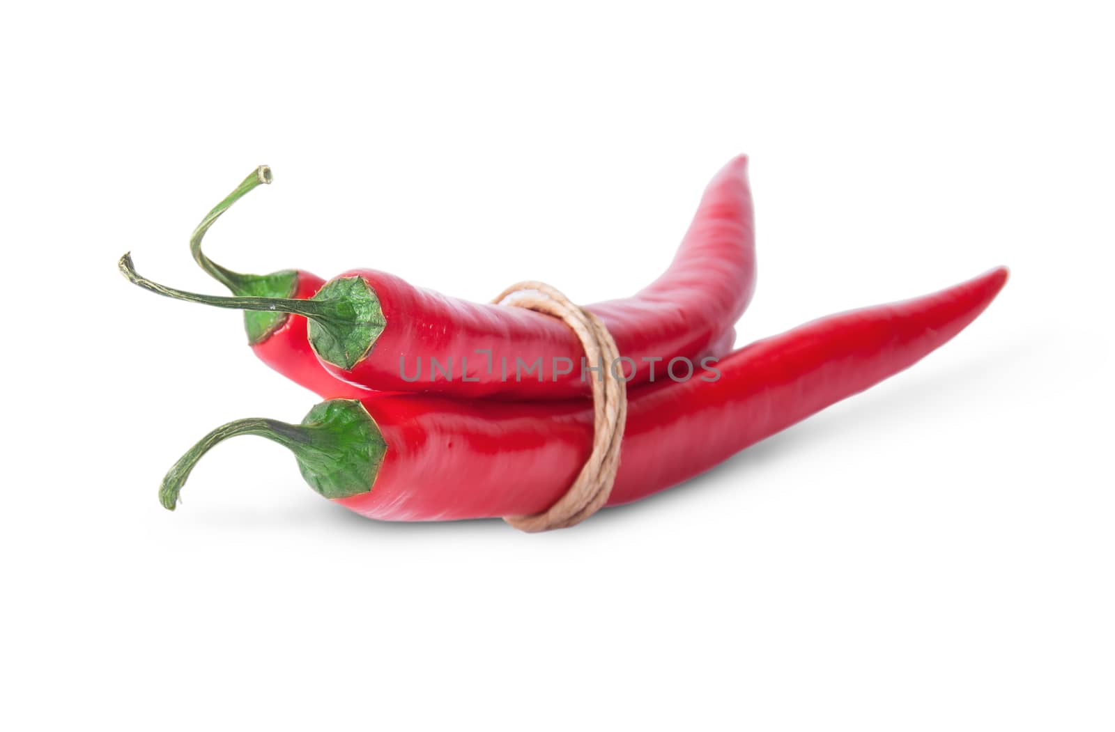 Three red chili peppers rotated tied with a rope isolated on white background