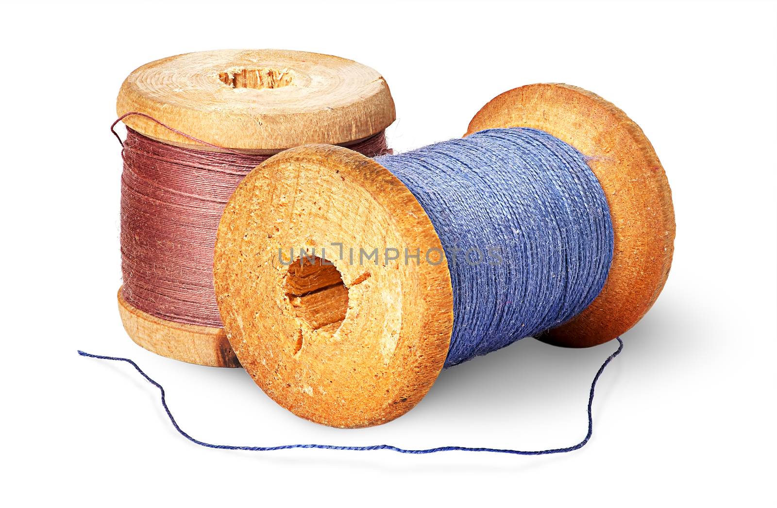 Two different colored thread on wooden spools isolated on white background