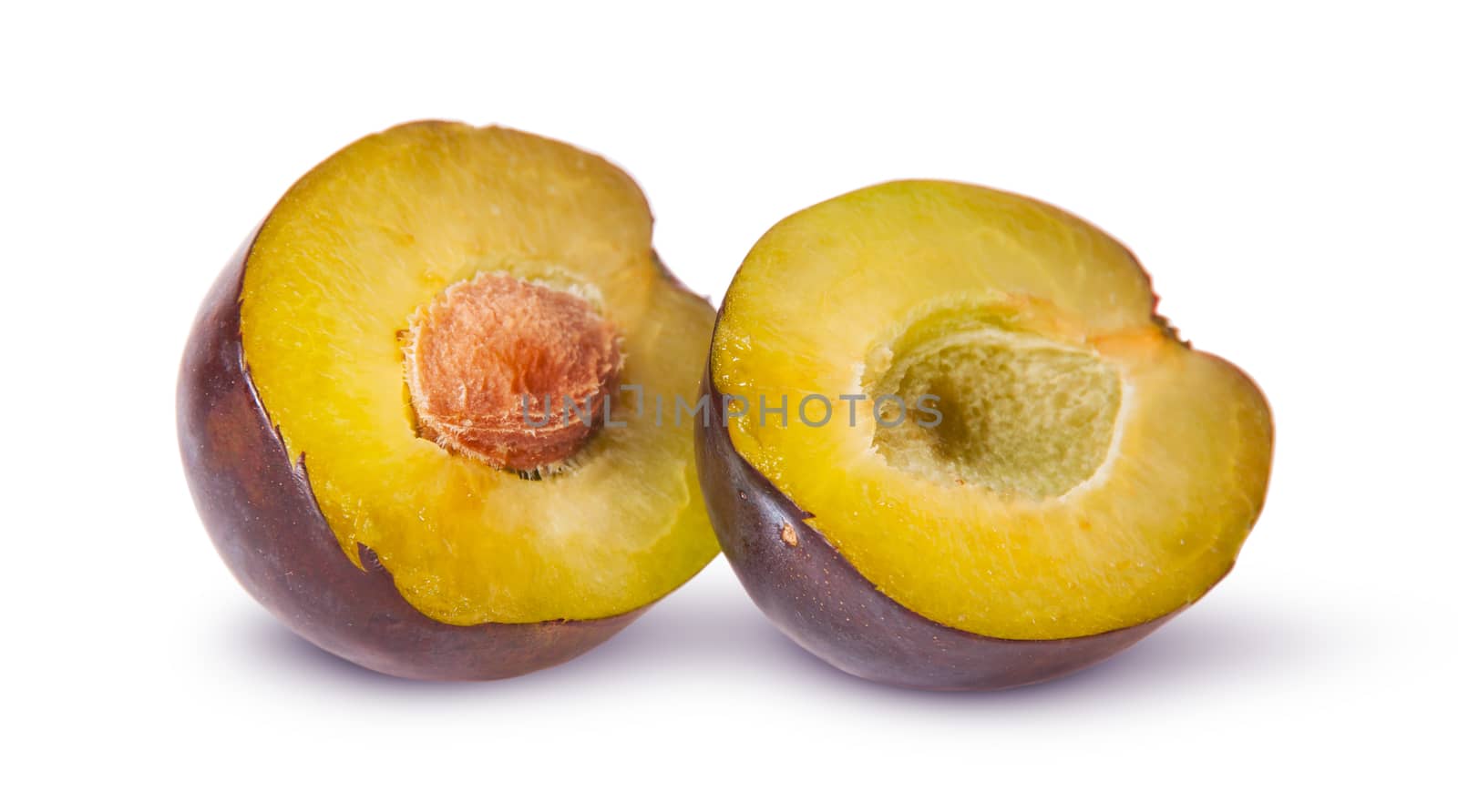 Two halves of violet plums near isolated on white background