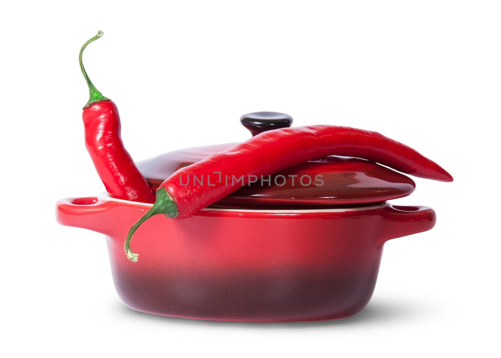 Two red chili peppers in saucepan with lid isolated on white background