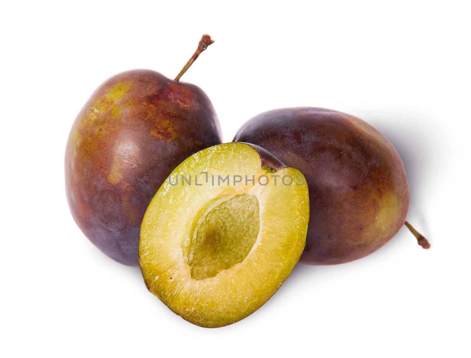 Two violet plums and half stand isolated on white background