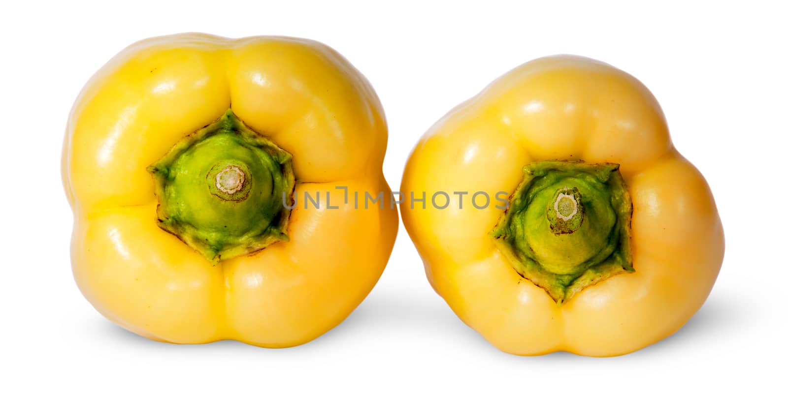 Two yellow bell peppers lying beside isolated on white background
