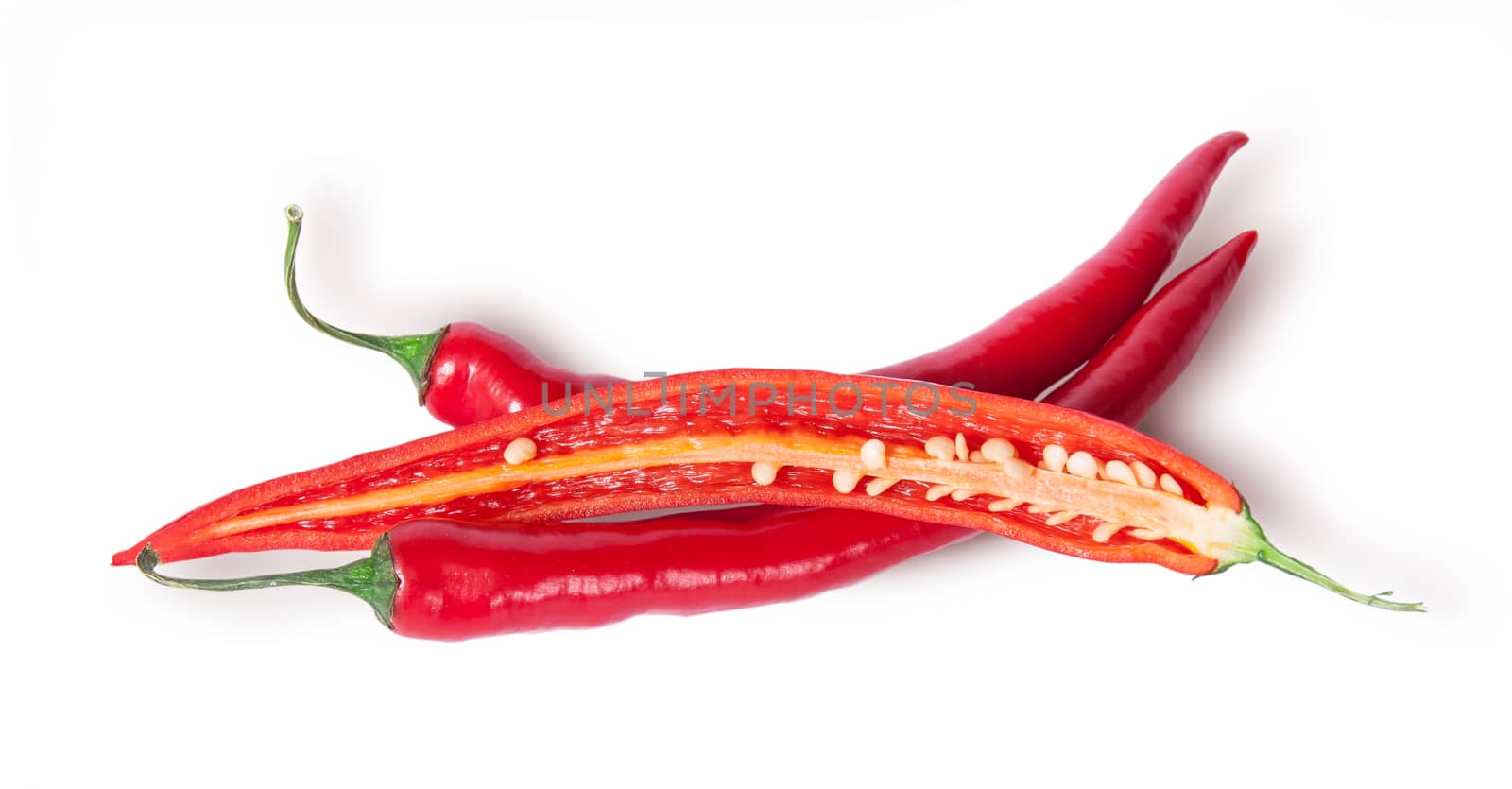 Two whole and one half red chili peppers isolated on white background