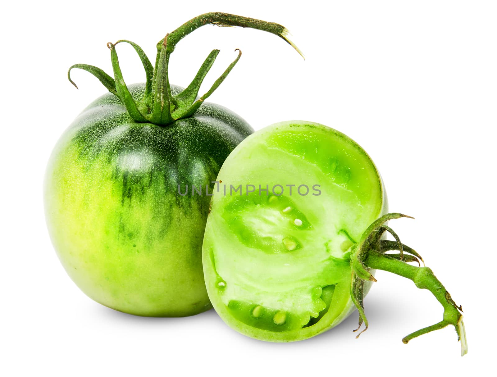 Whole and half green tomatoes isolated on white background