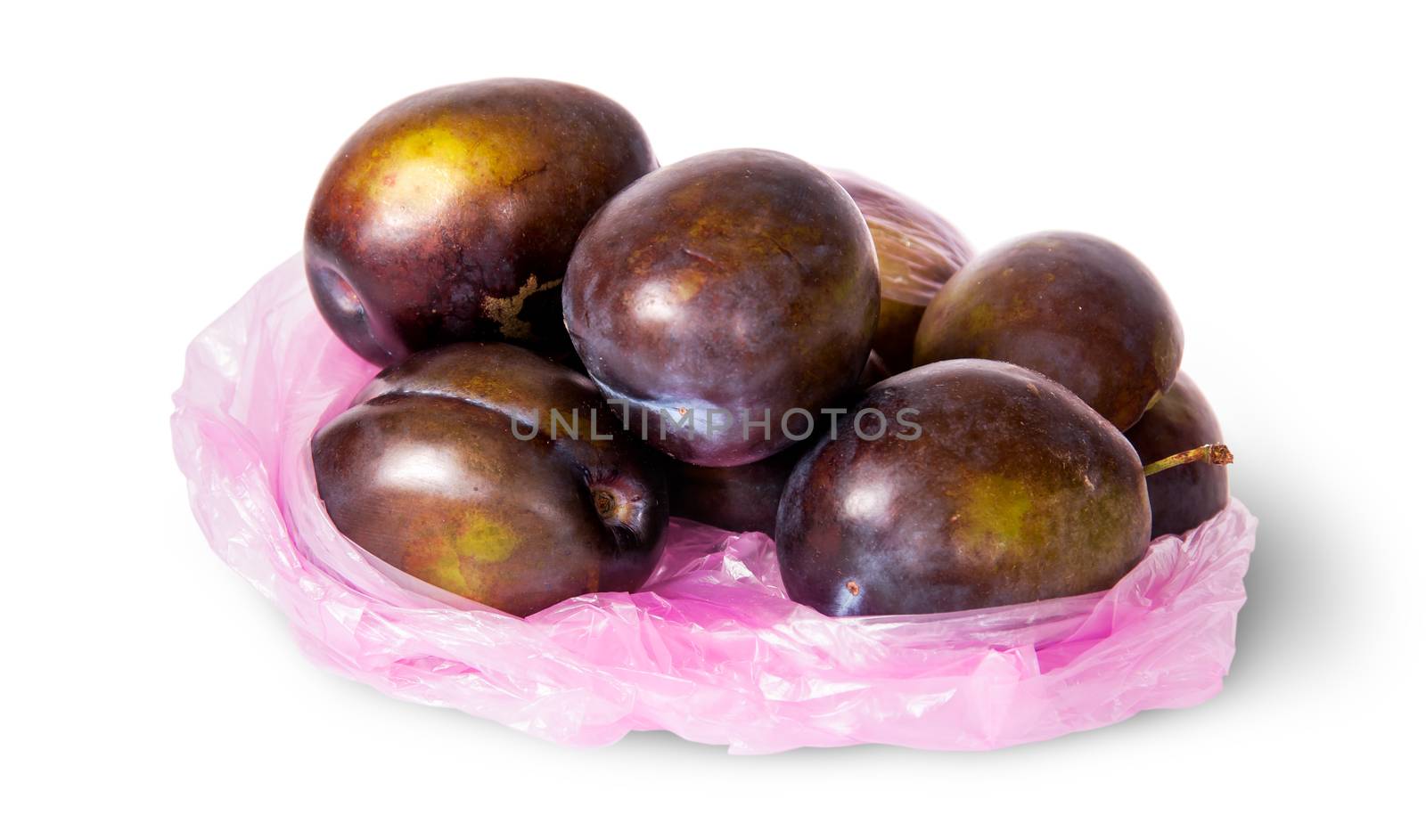 Whole violet plums in plastic bag isolated on white background