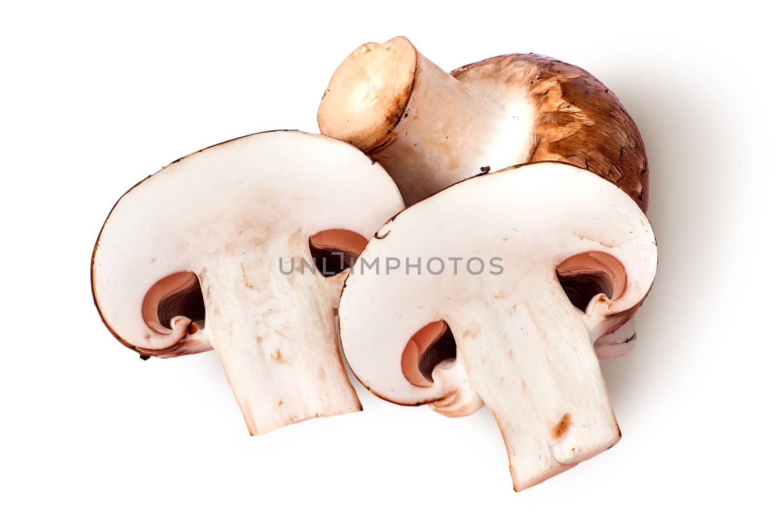 Whole and two half brown champignons by Cipariss
