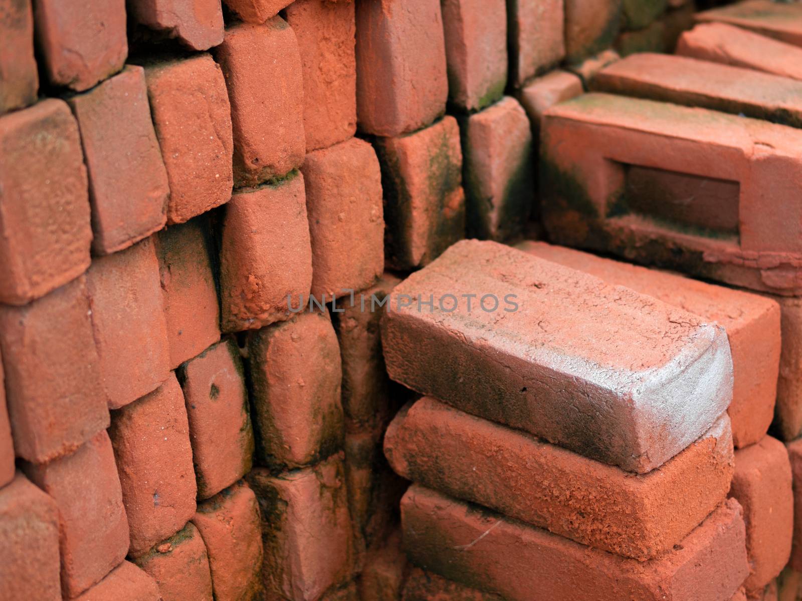 COLOR PHOTO OF PILE OF RED CLAY BRICKS