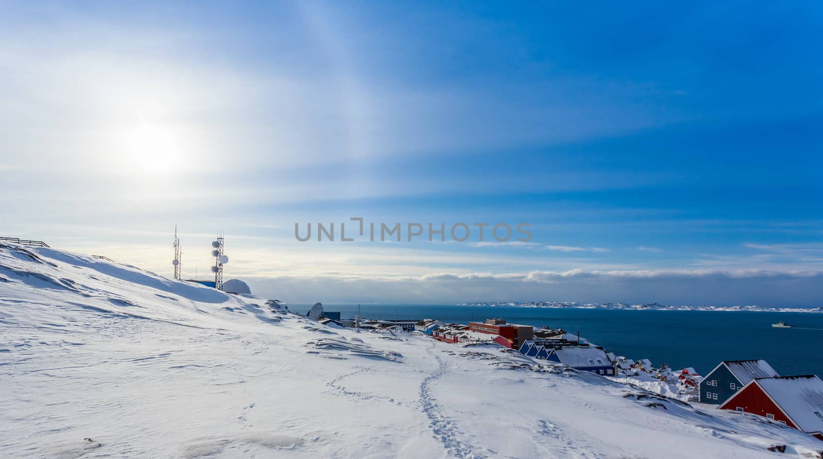 Arctic Sun Halo shining over houses at the fjord of Nuuk city, Greenland