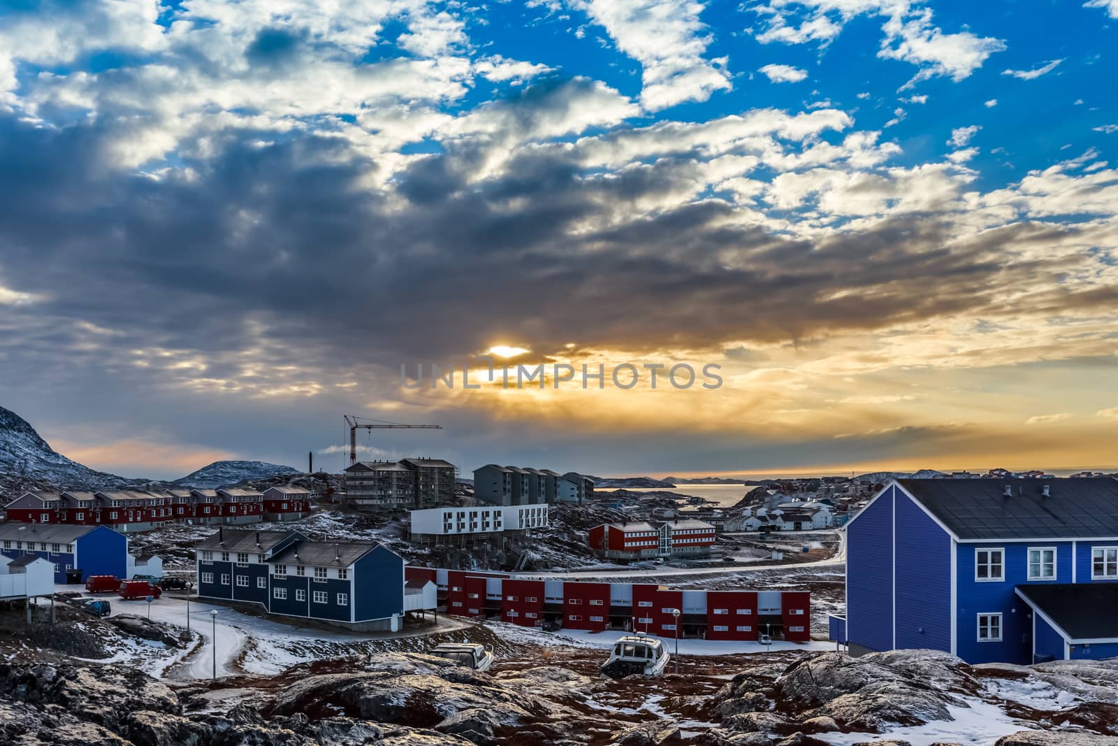 Arctic houses growing on the rocky hills in sunset panorama. Nuu by ambeon