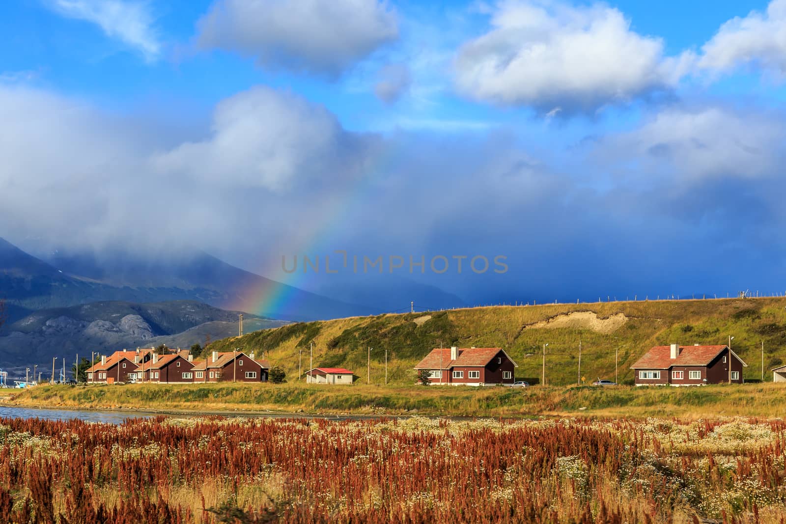 Rainbow over village with mountains in the background, Ushuaia,  by ambeon
