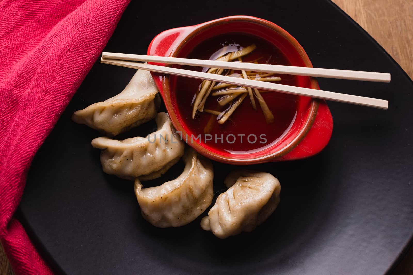 fried pork dumplings with a soy sauce and chopsticks