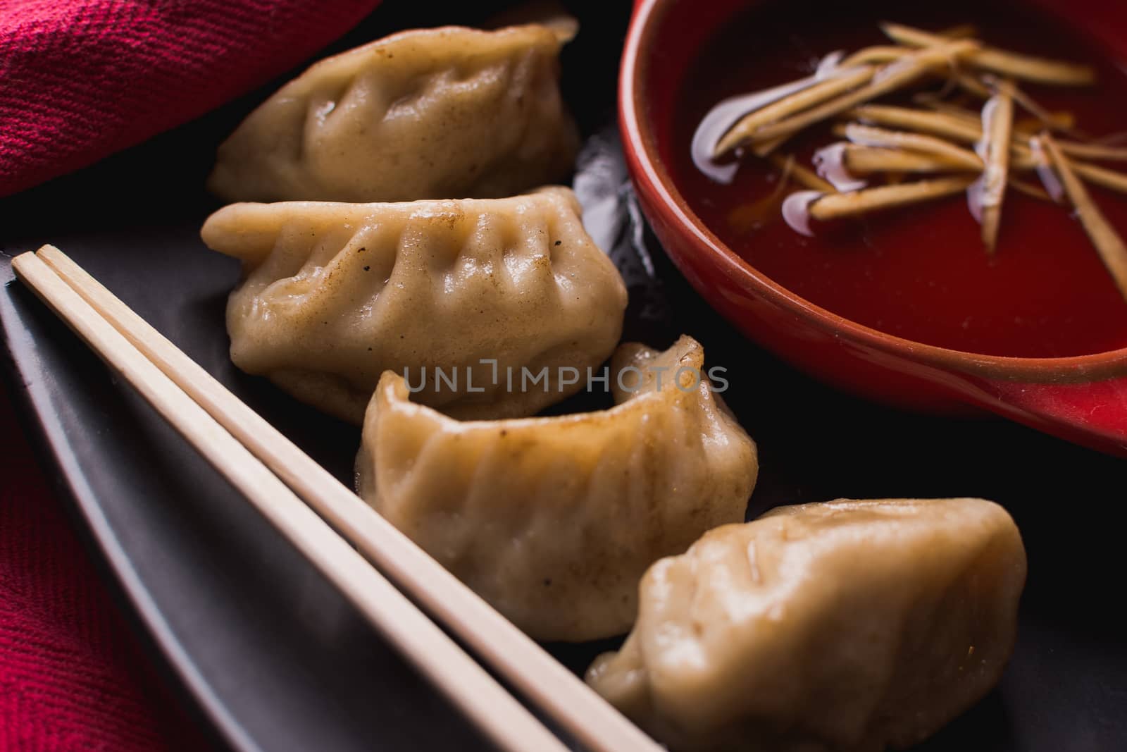 fried pork dumplings with a soy sauce and chopsticks