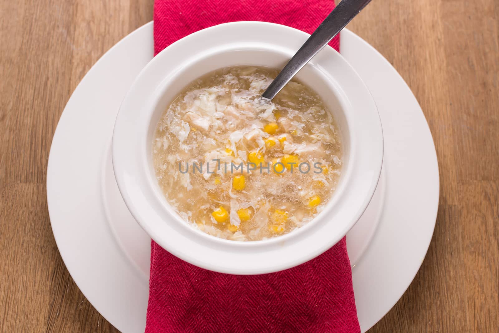 chicken sweetcorn soup in a bowl with a spoon