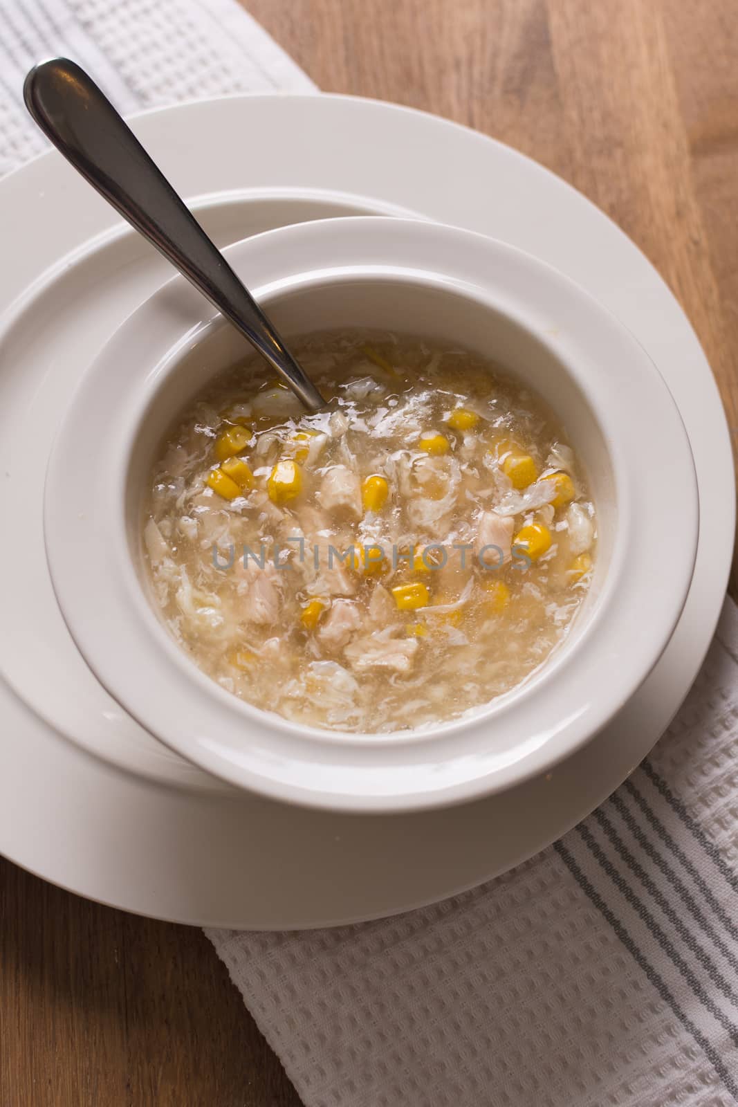 chicken sweetcorn soup in a bowl with a spoon