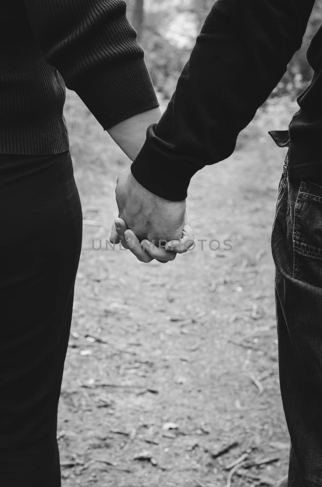 couple standing holding hands outdoors