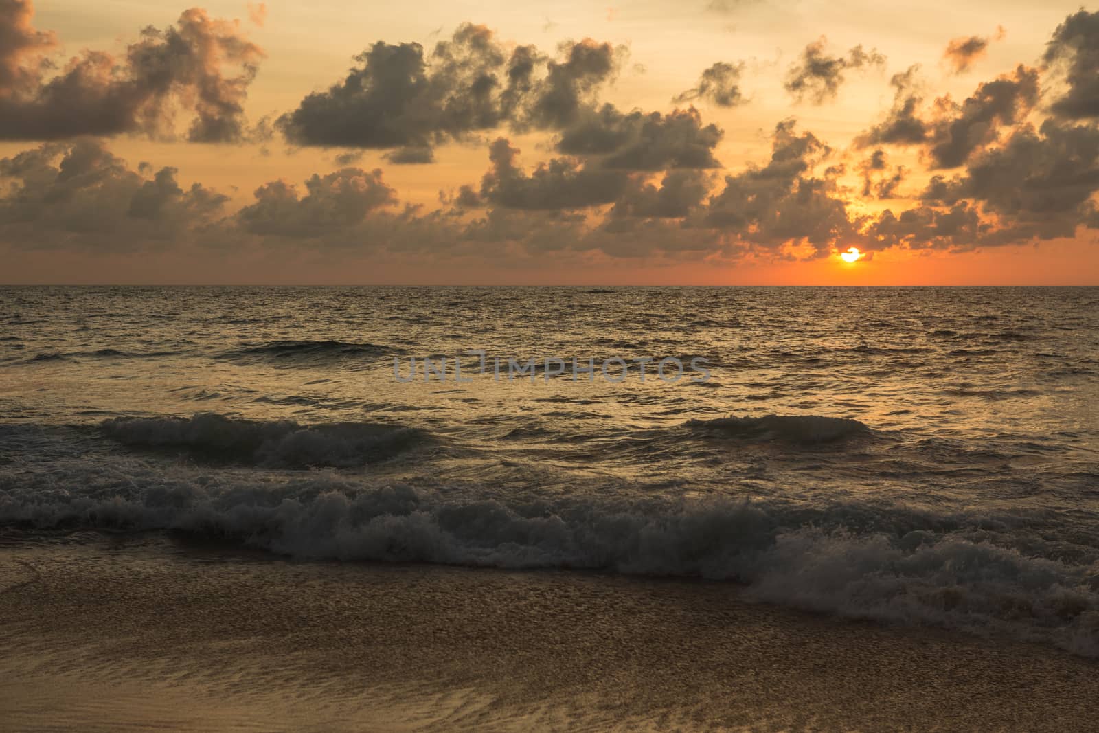 a beautiful sunset in the sea on the beach