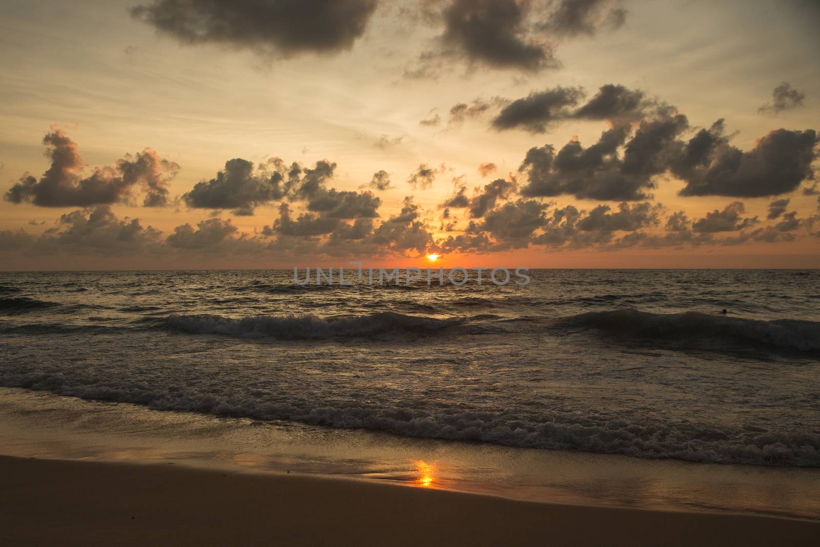 a beautiful sunset in the sea on the beach