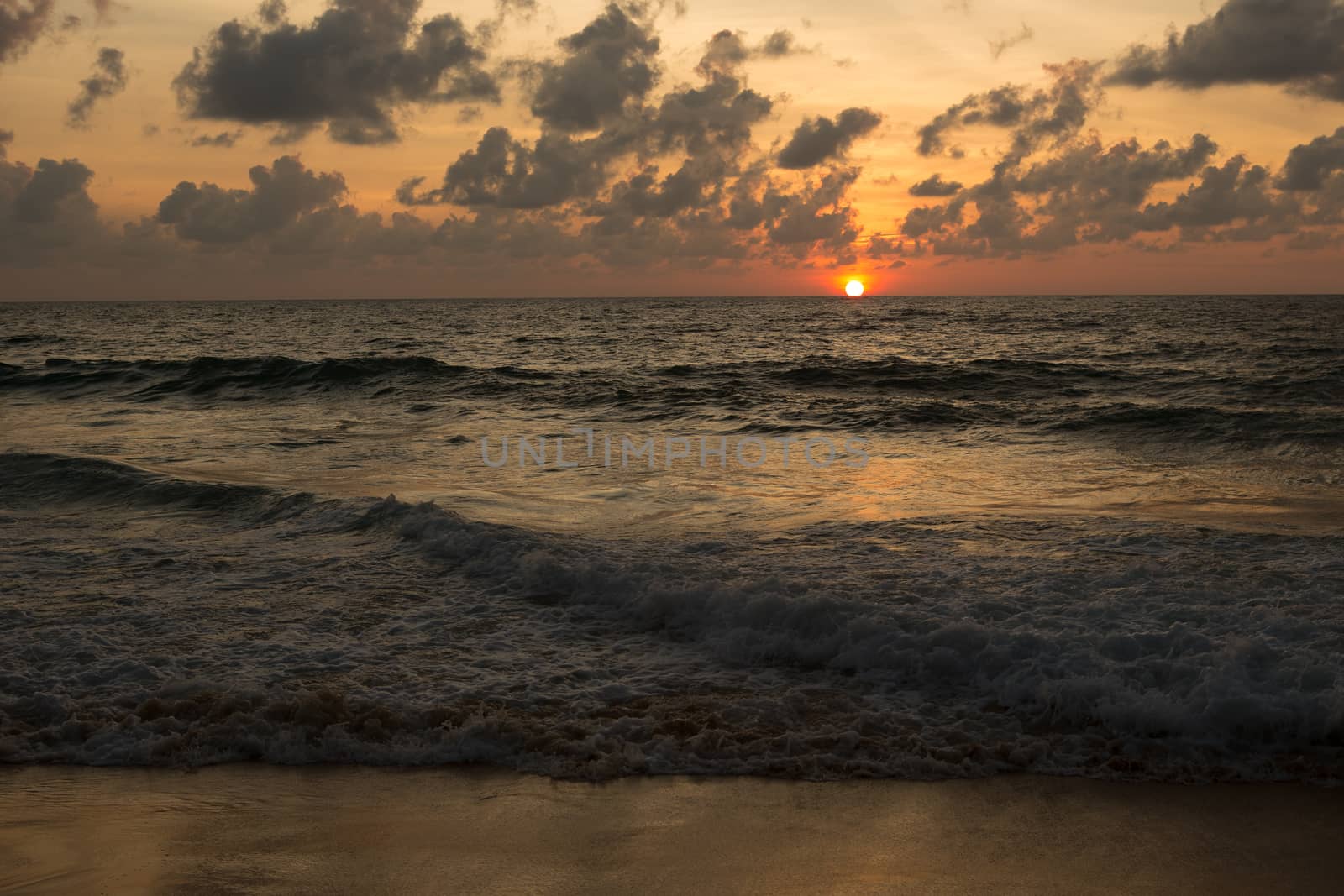 a beautiful sunset in the sea on the beach