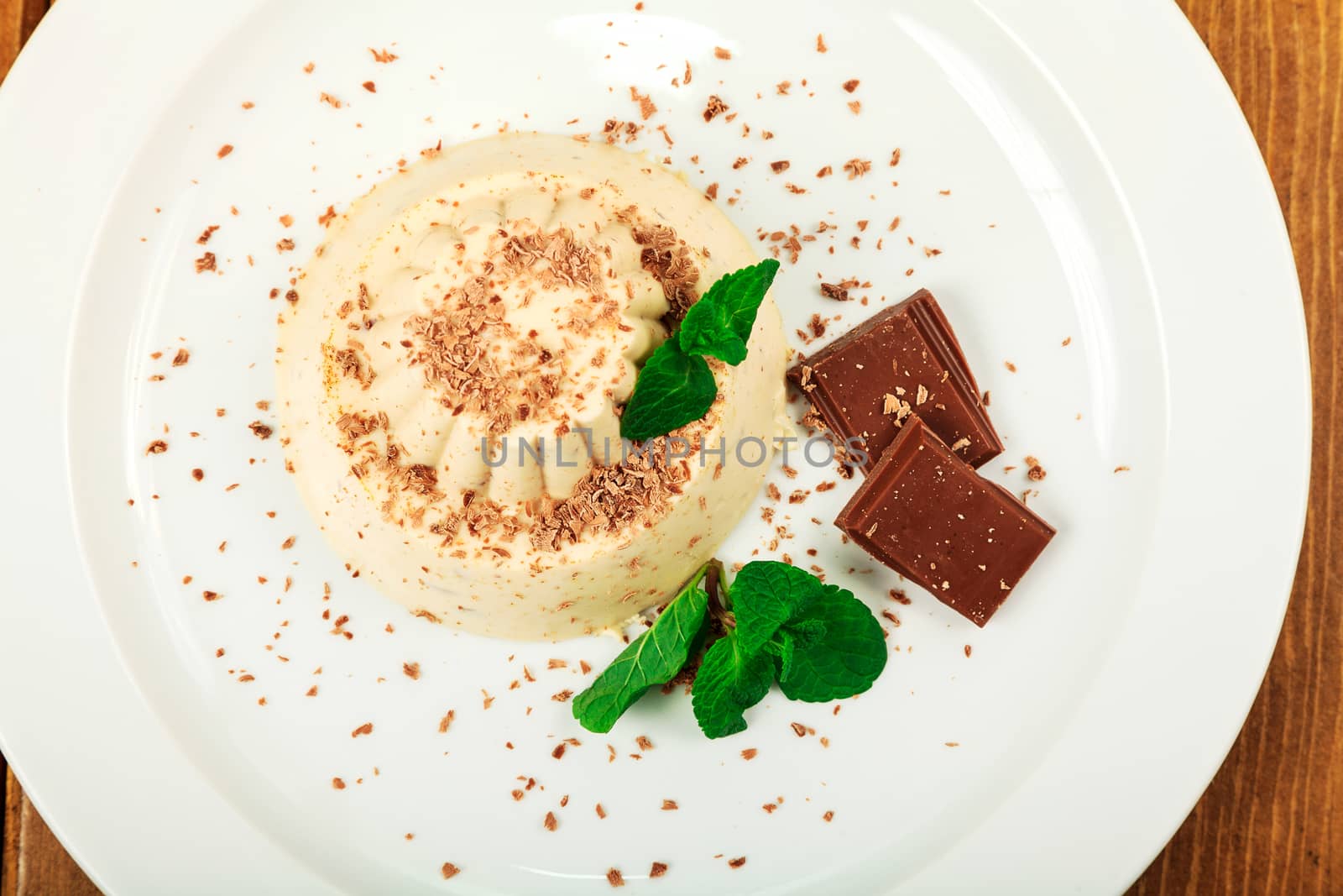 Blancmange with chocolate on glass plate by Nobilior