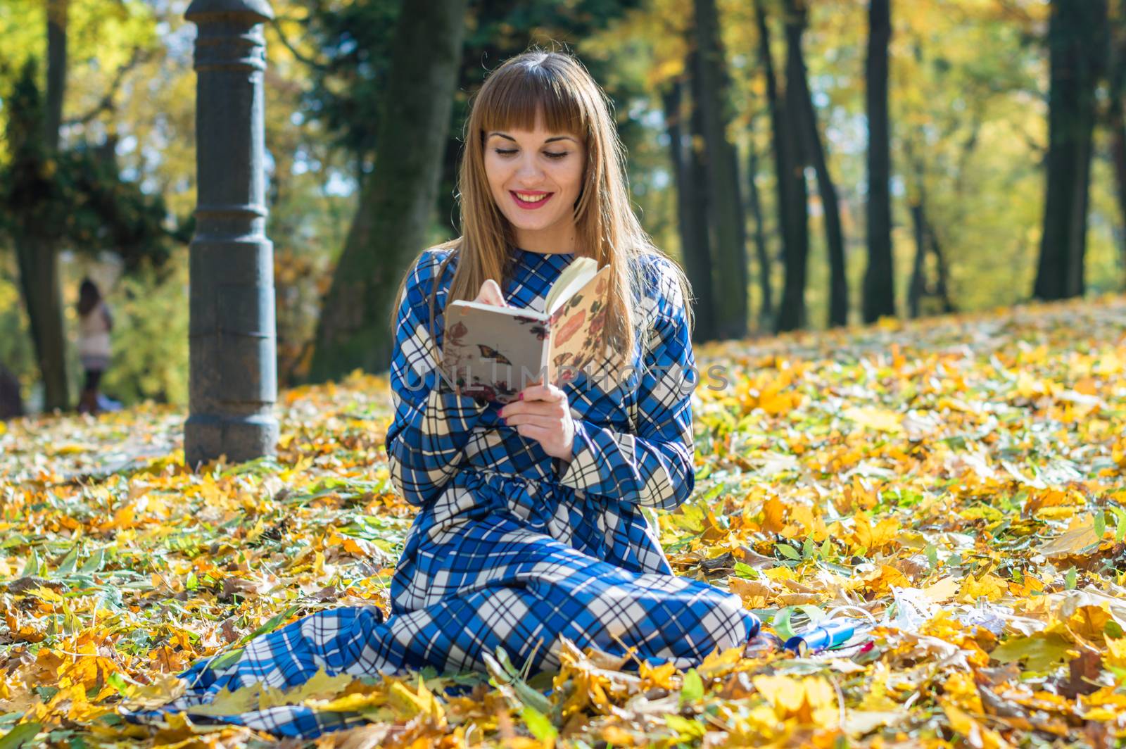 girl reading book in park by okskukuruza