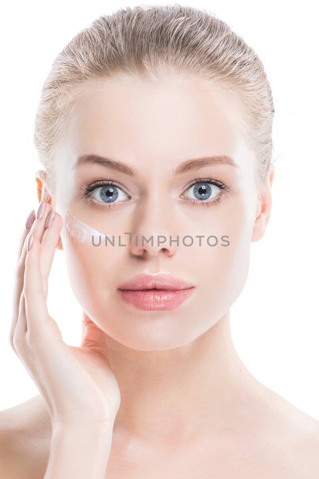 Beautiful young woman with cream on clean fresh face skin close up isolated on white background