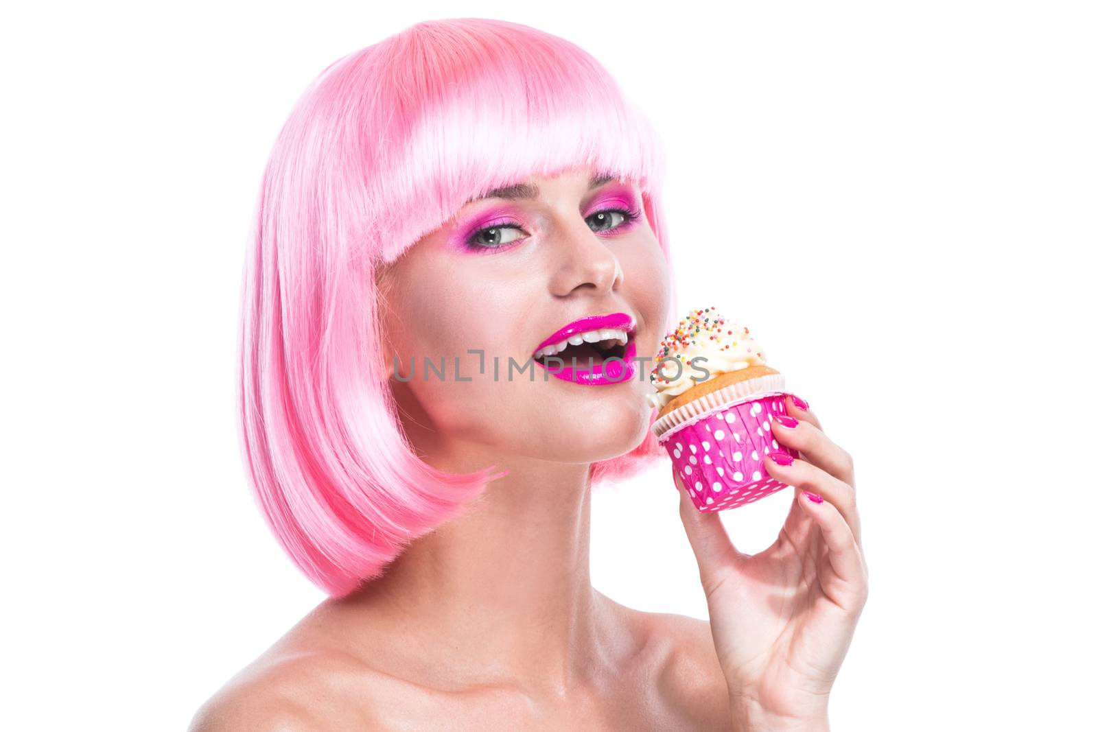 Portrait of girl with glamour make-up and pink hair ready to eat a cake isolated on white background