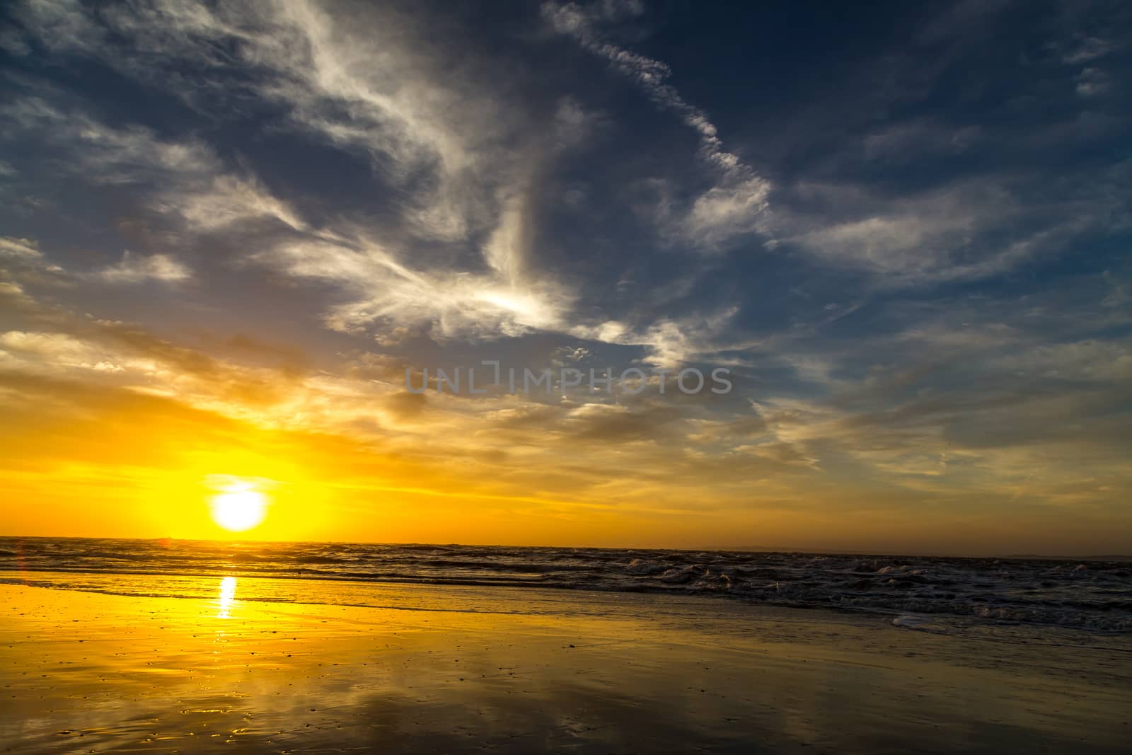 The sun rises at the beach on a cloudy morning over Amelia Island, Florida.