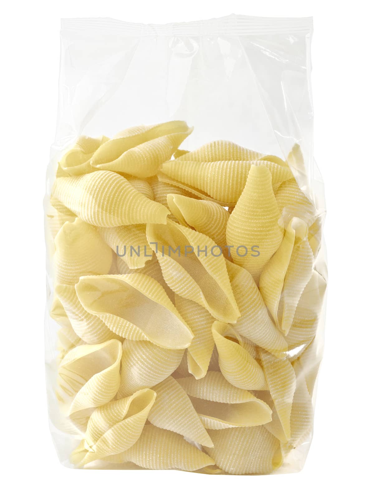close up of raw uncooked italian conchiglie jumbo shell pasta in plastic bag isolated